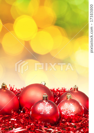 Xmas red bauble on blurred yellow green background Xmas red bauble on blurred yellow green background 17383800
