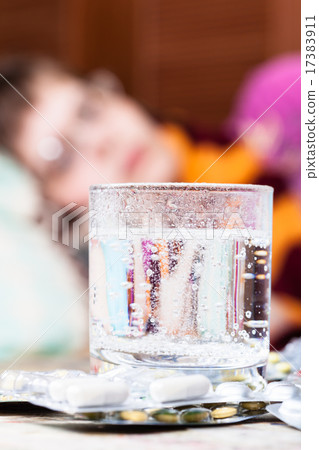 glass with dissolved medicament in and pills 17383911