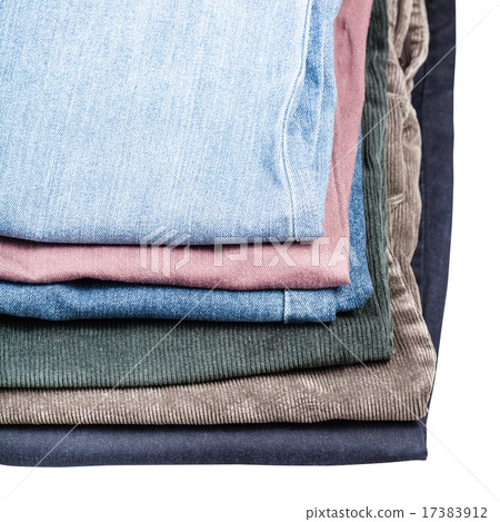 stack of different jeans and corduroys close up 17383912