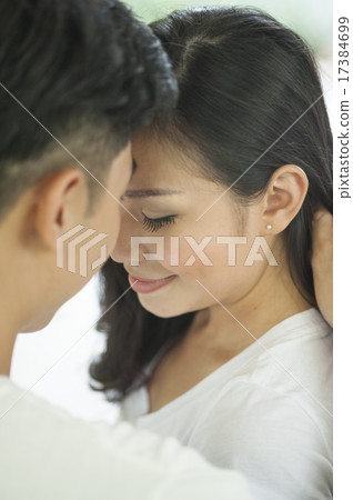A couple facing each other in a park. A couple facing each other in a park. 17384699