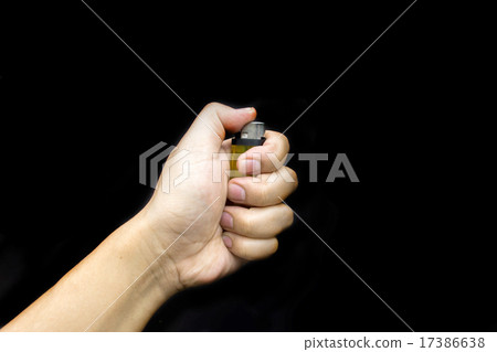 hold ligther in dark background 17386638