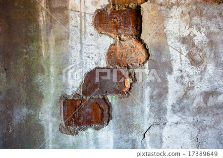 Bricks visible in the split plaster of the wall Bricks visible in the split plaster of the wall 17389649
