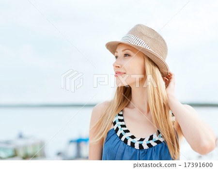 girl in hat standing on the beach girl in hat standing on the beach 17391600