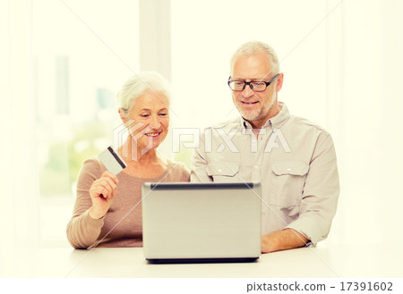happy senior couple with laptop and credit card happy senior couple with laptop and credit card 17391602
