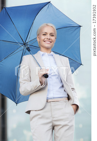 young smiling businesswoman with umbrella outdoors 17391932