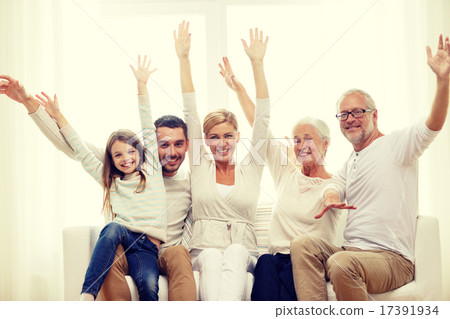 happy family sitting on sofa at home 17391934
