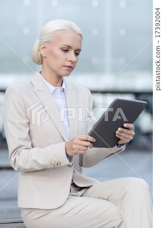 businesswoman working with tablet pc outdoors businesswoman working with tablet pc outdoors 17392004