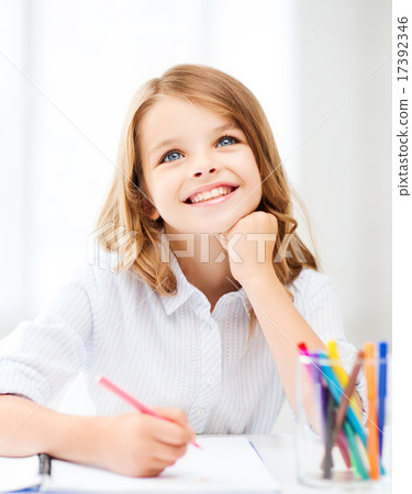 smiling little student girl drawing at school smiling little student girl drawing at school 17392346