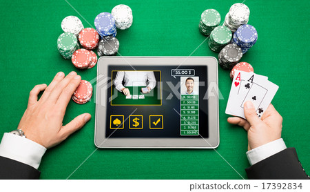 casino player with cards, tablet pc and chips casino player with cards, tablet pc and chips 17392834