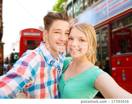 happy couple taking selfie over london city 17393016