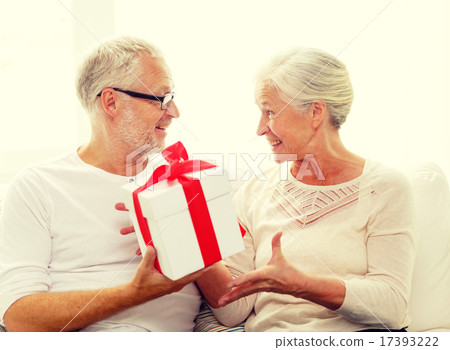happy senior couple with gift box at home 17393222