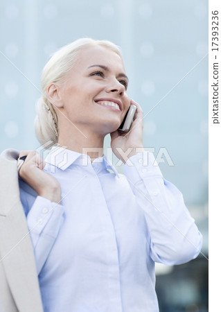smiling businesswoman with smartphone outdoors smiling businesswoman with smartphone outdoors 17393236