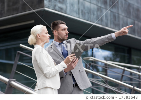 serious businessmen with tablet pc outdoors 17393648