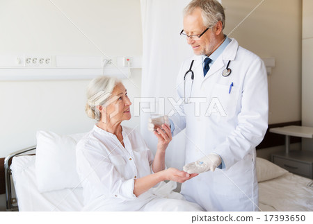 doctor giving medicine to senior woman at hospital doctor giving medicine to senior woman at hospital 17393650