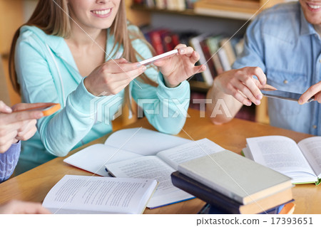 students with smartphones making cheat sheets students with smartphones making cheat sheets 17393651