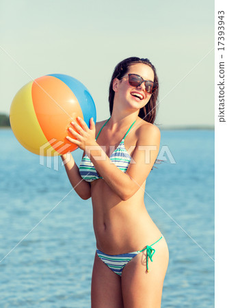 smiling teen girl in sunglasses with ball on beach smiling teen girl in sunglasses with ball on beach 17393943