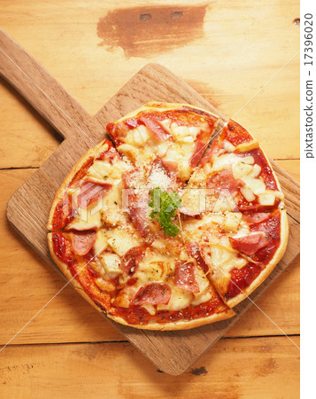 Hawaiian pizza on wood plate 17396020