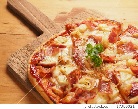 Hawaiin pizza on wood plate 17396021