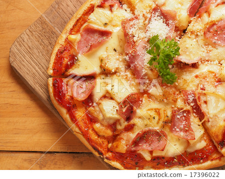 Hawaiian pizza on wood plate 17396022