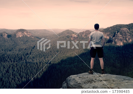 Adult hiker in grey shirt and dark pants. Tall man Adult hiker in grey shirt and dark pants. Tall man 17398485