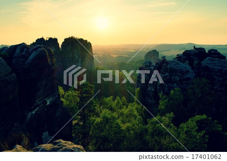 Lighted rocks and hills bellow sunset on horizon 17401062