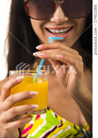 Lady is holding a glass in her arm. 17402066