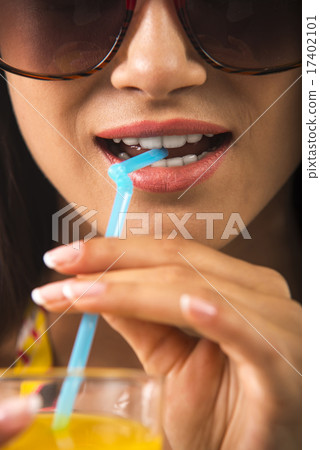 Girl is holding a glass in her arm. 17402101