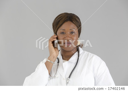 Black female doctor talking on telephone 17402146