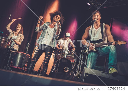 Multiracial music band performing on a stage Multiracial music band performing on a stage 17403624