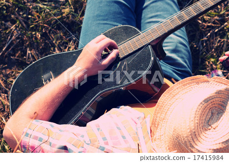 man with guitar and beer on the nature 17415984