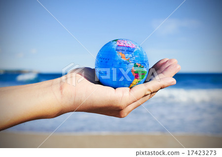 young man with a world globe in his hand young man with a world globe in his hand 17423273