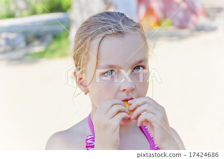 Cute girl biting a food Cute girl biting a food 17424686
