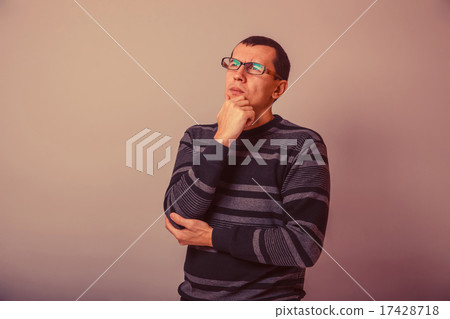 European-looking man of 30 years in glasses, thinking retro European-looking man of 30 years in glasses, thinking retro 17428718