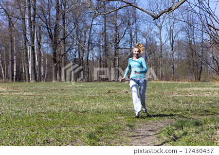 woman runs on the track in the spring wood 17430437