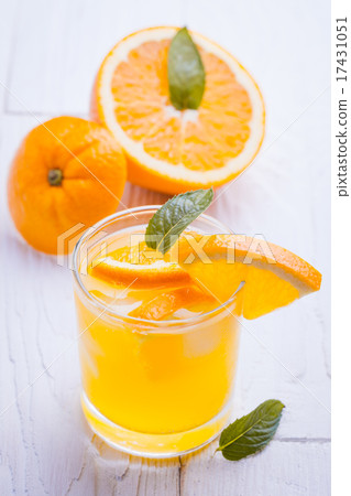 orange alcohol cocktail on a wooden table. 17431051