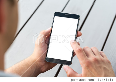 Man holding smart mobile phone on wooden table 17431414