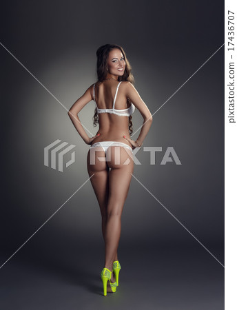 Rear view of smiling tanned model in underwear  17436707