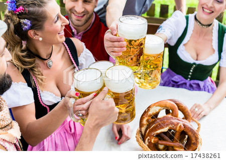 Clinking glasses with beer in Bavarian pub 17438261