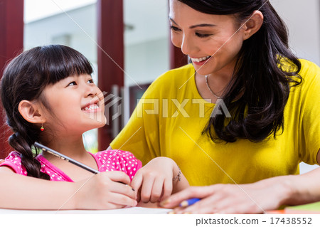 Stock Photo: Chinese mother homeschooling her child