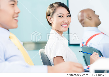 Chinese Businesswoman in meeting looking at camera 17438575