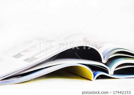 a pile of magazines close up on white background a pile of magazines close up on white background 17442153
