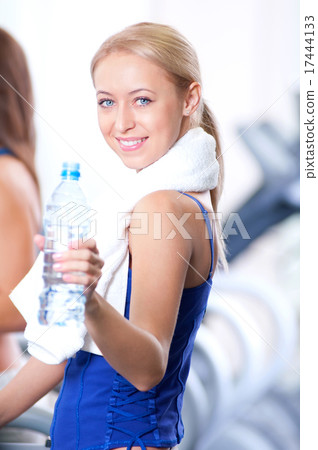 Women drinking water after sports 17444133