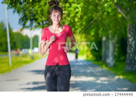 Runner - woman running outdoors in green park Runner - woman running outdoors in green park 17444449