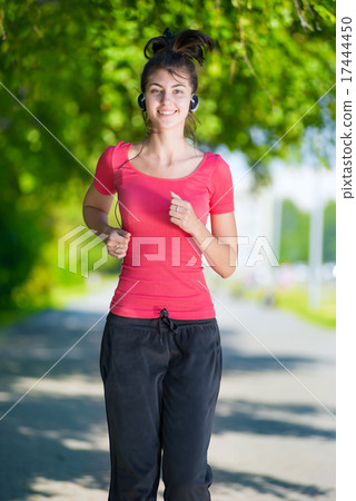 Runner - woman running outdoors in green park Runner - woman running outdoors in green park 17444450