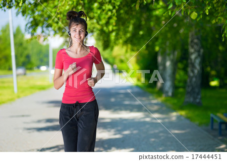 Runner - woman running outdoors in green park 17444451