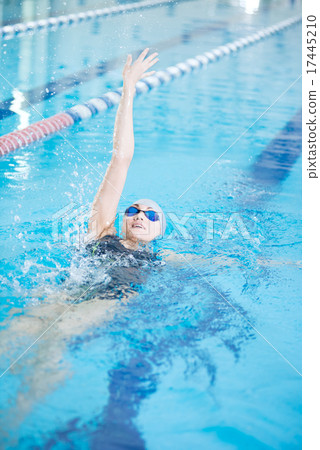 Young girl in goggles swimming back crawl stroke style 17445210