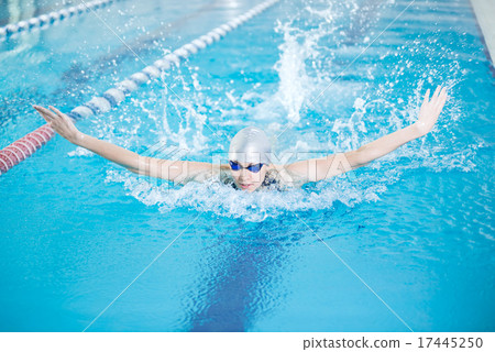 Young girl in goggles swimming butterfly stroke style 17445250