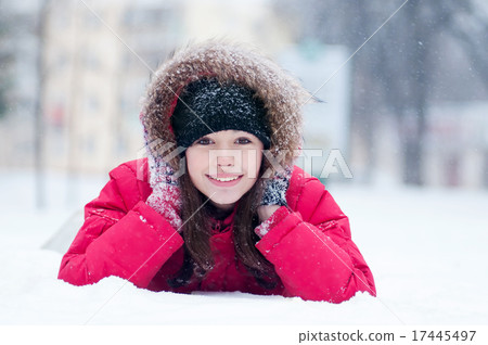 Happy young woman plays with a snow 17445497