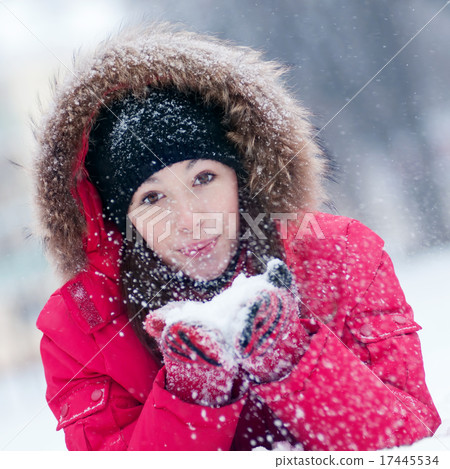 Happy young woman plays with a snow Happy young woman plays with a snow 17445534