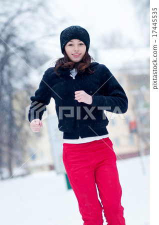 Young girl running on a cold winter day 17445535